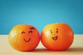 Image of two clementines with drawn smiley faces Royalty Free Stock Photo