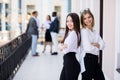 Portrait of two confident businesswomen in formalwear looking forwards in front of business team Royalty Free Stock Photo