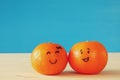 Image of two cute clementines with drawn smiley faces Royalty Free Stock Photo