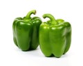 Two green sweet bell peppers are isolated on white.