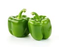 Two green sweet bell peppers are isolated on white.