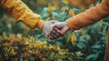 A image of two individuals standing in front of a bush, holding hands Royalty Free Stock Photo