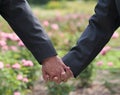 Image of two men Holding hands at gay Wedding