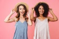 Image of two positive summer women with different color of skin Royalty Free Stock Photo