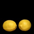 Two ripe lemons on black background Royalty Free Stock Photo