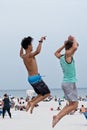 Two young men doing backflips on the sand at Pensacola Beach, Florida USA Royalty Free Stock Photo