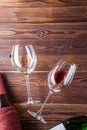 Image of two wine bottles and wine glasses on brown, wooden background. Royalty Free Stock Photo