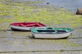 Red and green wooden fishing boats dries ashore Royalty Free Stock Photo
