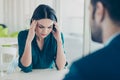 Image of two workers at a meeting in a restaurant. Young pretty exhausted businesswoman having headache because of Royalty Free Stock Photo