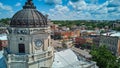 Up close to top of Bloomington Indiana courthouse clock with downtown in background Royalty Free Stock Photo