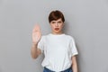 Image of uptight brunette woman frowning and gesturing stop with hand Royalty Free Stock Photo