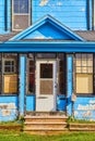 Urban building with chipped blue and white paint at 615 house and mailbox