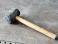 Image of used rubber hammer on the metal table. Royalty Free Stock Photo