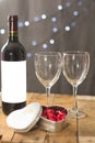 Image of Valentine`s day, symbols of love, bottle and glasses of wine, sweets on a background of wooden boards. Royalty Free Stock Photo