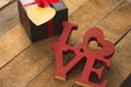 Image of Valentine`s day, symbols of love, gift box on a background of wooden planks. 3 Royalty Free Stock Photo