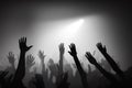 image of the a vast crowd of hands, illuminated by a dreamy and foggy light towards the front auditorium.