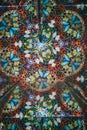 Vertical close up view of interior of kaleidoscope with multiple multicolored butterflies
