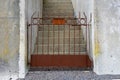 Old Rusted Metal Gate and Concrete Retaining Wall Royalty Free Stock Photo