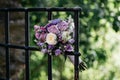 Image of a vibrant bouquet of flowers resting on a fence in a forest landscape Royalty Free Stock Photo