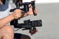 Videographer shoots video with mirrorless camera with stabilizer