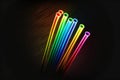 Image of vint neon glow sticks forming rainbow, abstract, colors