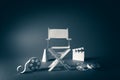 Image with vintage texture of a Director chair and movie items Royalty Free Stock Photo