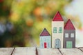 Image of vintage wooden colorful houses decoration on wooden table in front of blured background