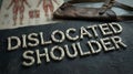 Dislocated Shoulder Text Made of Bone Fragments with Medical Anatomy Chart and Sling Royalty Free Stock Photo