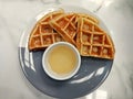 image of waffles with honey syrup for breakfast .