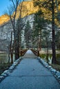 Walking bridge leading towards El Capitan mountains at Yosemite during sunrise