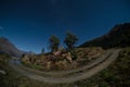 This image was taken using fisheye lens. The night sky is blue and there are many stars in the sky. There is a gravel road in the Royalty Free Stock Photo