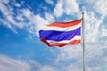 Image of waving Thai flag of Thailand with blue sky background.