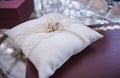 An image of wedding rings on the white pillow