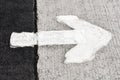 An image of a white arrow painted on the road Royalty Free Stock Photo