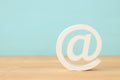 image of white mail icon over wooden desk.