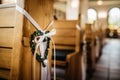 Image of a white satin wedding ribbon tied in a bow on top of a wooden church pew Royalty Free Stock Photo