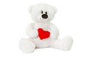 Image of white toy teddy bear holding red heart and sitting at isolated white background Royalty Free Stock Photo