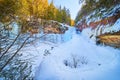 Wide view of large frozen waterfall in winter on cliffs Royalty Free Stock Photo