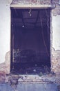 Window hole into abandoned building interior