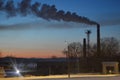 Winter landscape with boiler room chimney in the evening Royalty Free Stock Photo