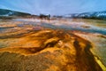 Winter at Yellowstone basin with pools of alkaline water making colorful waves