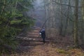 Image of a woman asking if she can follow a path that is obstructed by fallen tree trunks Royalty Free Stock Photo