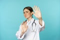 Image of woman doctor cringe, looking with dislike or aversion, rejecting, saying no, stay away, step back from Royalty Free Stock Photo