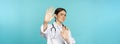 Image of woman doctor cringe, looking with dislike or aversion, rejecting, saying no, stay away, step back from Royalty Free Stock Photo