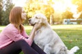 Image of woman embracing labrador