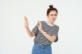 Image of woman expressing aversion, dislike something, looks apalled, extends hands forward in defensive gesture Royalty Free Stock Photo