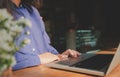 Image of woman hands using / typing on laptop computer selected focus on keyboard