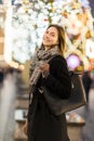 Image of woman outside in evening on blurred background with garland Royalty Free Stock Photo