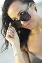 Image of a woman removing her sunglasses Royalty Free Stock Photo