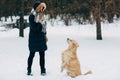 Image of woman with retriever walking in winter park Royalty Free Stock Photo